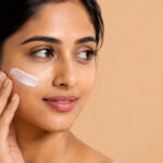 Woman applying moisturizer as part of a monsoon skincare routine